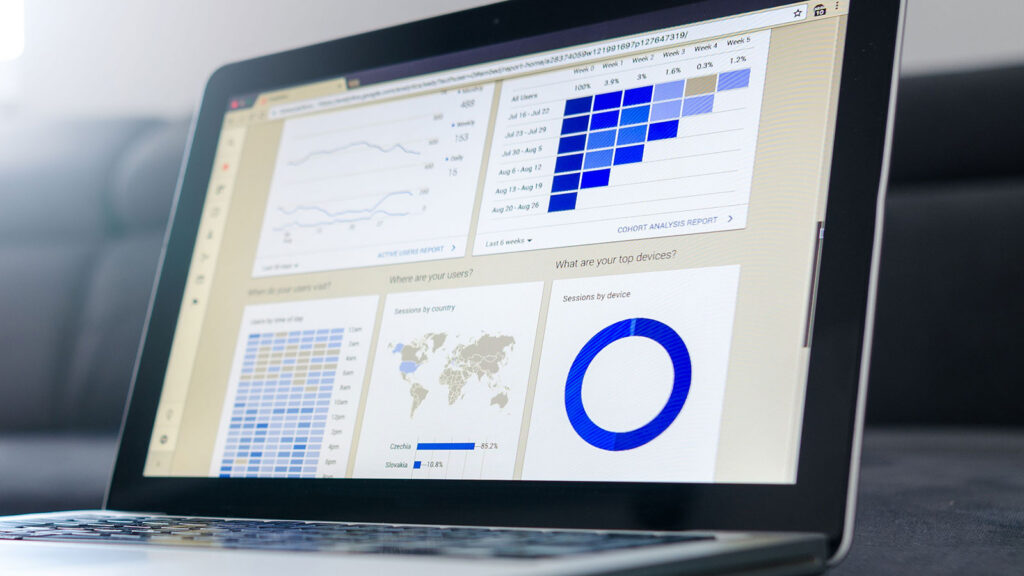 A laptop showcasing data analytics and graphs on the screen